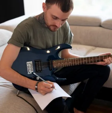 man playing guitar home