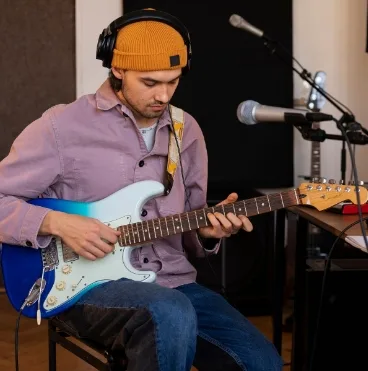 man working music studio with instruments